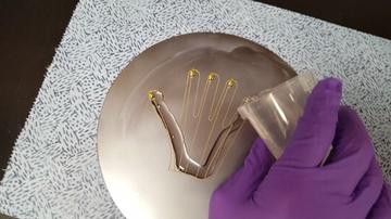 Pouring PDMS over printed conductive material