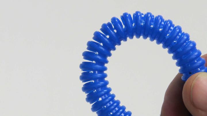 Ribbed hose with cuts and stress relief holes